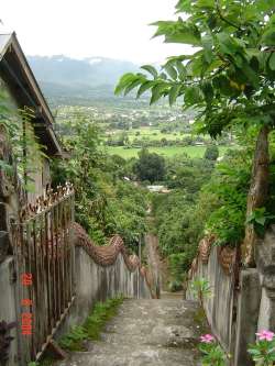 we've parked the bike and are halfway up these massive steps when we cross the road we thought went somewhere else