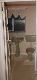plastic cistern and dusty drapes