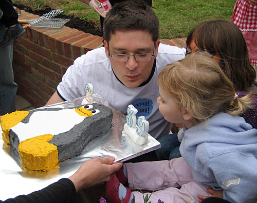 Steve and Natasha blow out Tux's candles