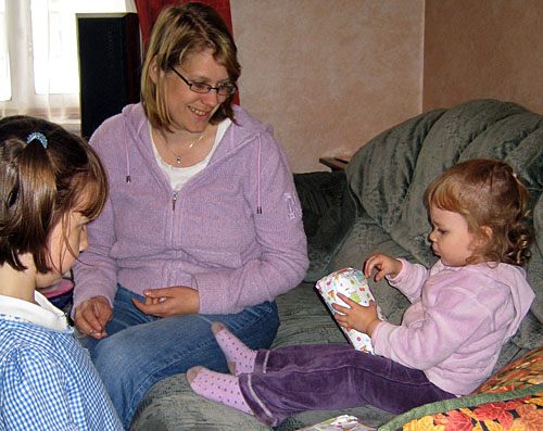 Amy and Mummy help Natasha open her presents