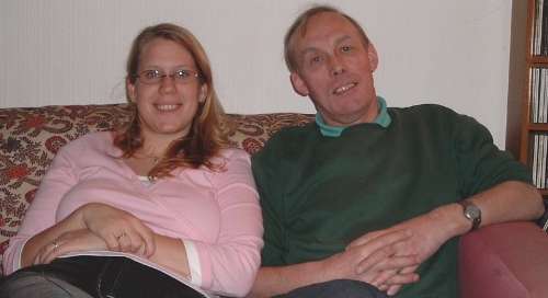 Heather and dad, Ian, sitting on his sofa